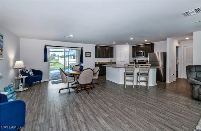 dining space with dark hardwood / wood-style floors