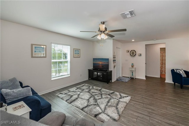 living room with ceiling fan and dark hardwood / wood-style flooring