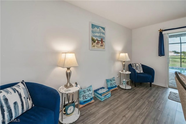 sitting room with hardwood / wood-style flooring