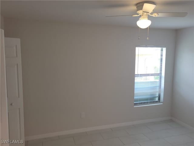 spare room with light tile patterned floors and ceiling fan