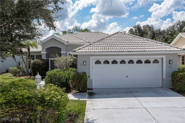 mediterranean / spanish home featuring a garage