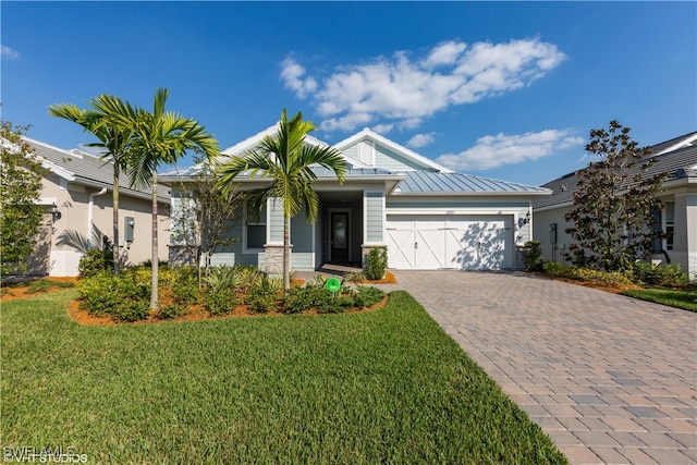 view of front of house featuring a front yard and a garage