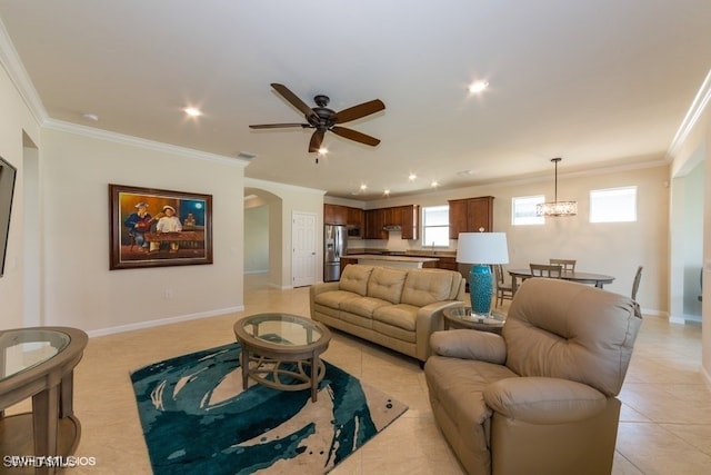 living room with crown molding, ceiling fan with notable chandelier, sink, and light tile patterned floors