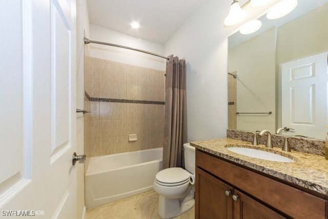 full bathroom with vanity, shower / tub combo, toilet, and tile patterned floors