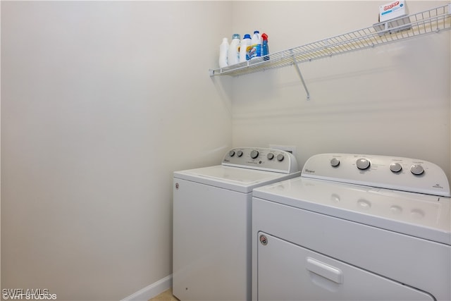 laundry room featuring washing machine and clothes dryer