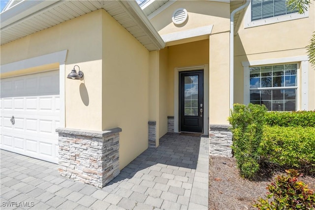 doorway to property with a garage