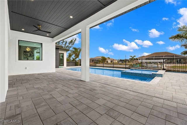 view of pool with ceiling fan, an in ground hot tub, and a patio