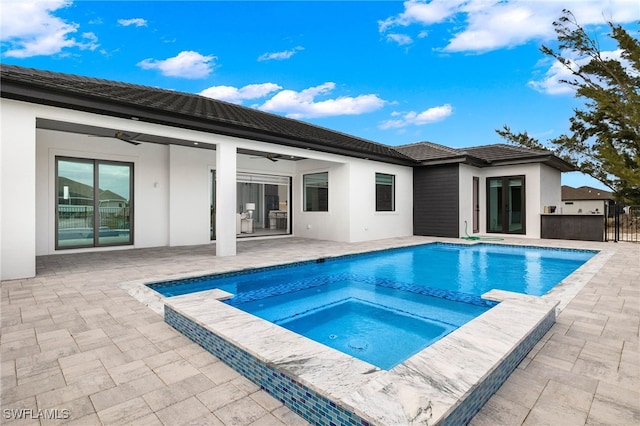 view of pool with ceiling fan, an in ground hot tub, and a patio area