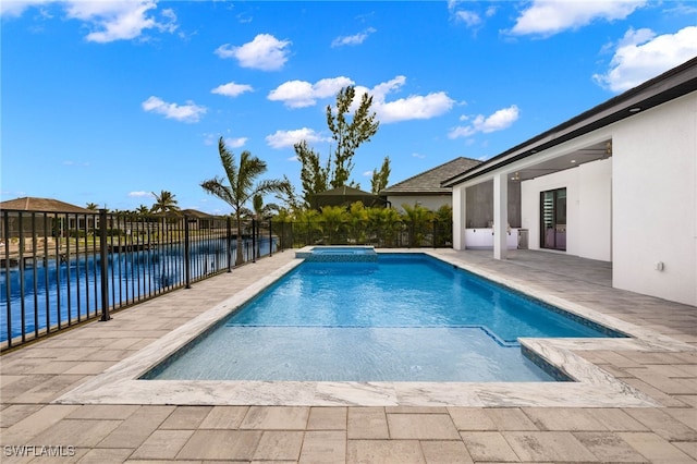 view of swimming pool with a water view and a patio area