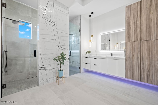 bathroom featuring walk in shower and vanity