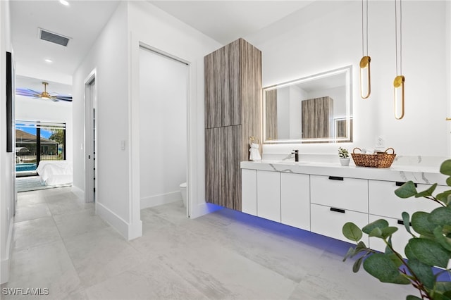 bathroom featuring ceiling fan, vanity, and toilet