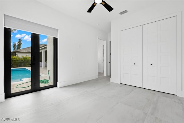 unfurnished bedroom featuring a closet, access to exterior, and ceiling fan