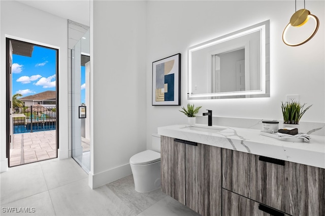 bathroom featuring vanity, toilet, and tile patterned floors