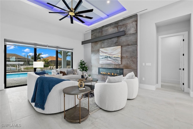 living room with ceiling fan, light tile patterned flooring, and a fireplace