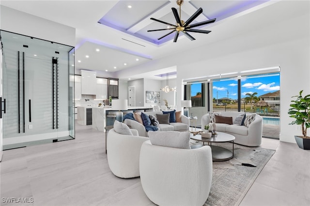 living room with ceiling fan with notable chandelier