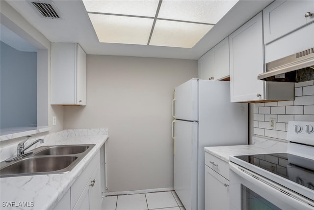 kitchen with decorative backsplash, white appliances, sink, white cabinetry, and light tile patterned floors