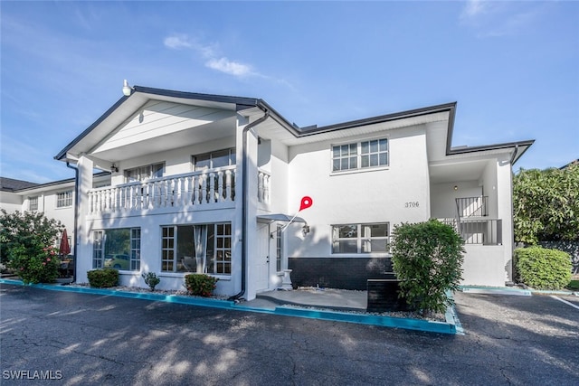 view of front of property with a balcony