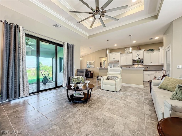 646 NE 5th Place, Cape Coral, FL 33909 - living room featuring a raised ceiling, a ceiling fan, crown molding, and recessed lighting