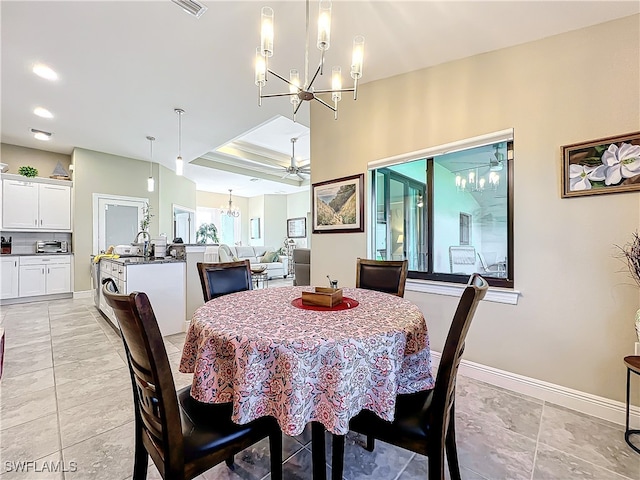 dining area with sink, light tile patterned floors, and ceiling fan with notable chandelier