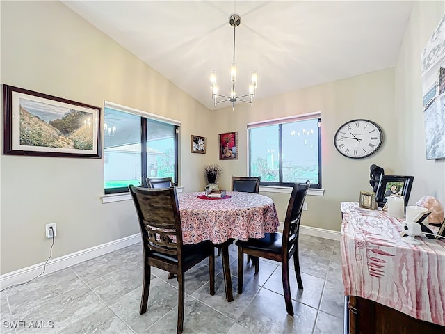 dining room featuring an inviting chandelier and vaulted ceiling