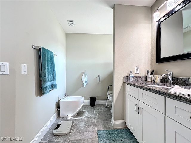 bathroom featuring vanity and a washtub