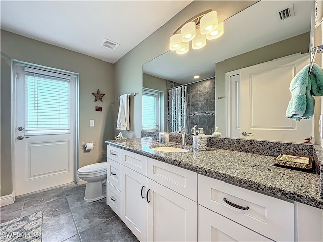 bathroom featuring vanity, toilet, and walk in shower