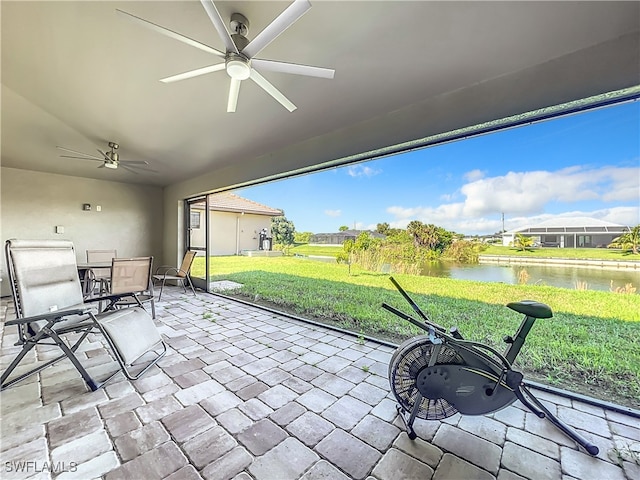 view of patio / terrace with a water view and ceiling fan