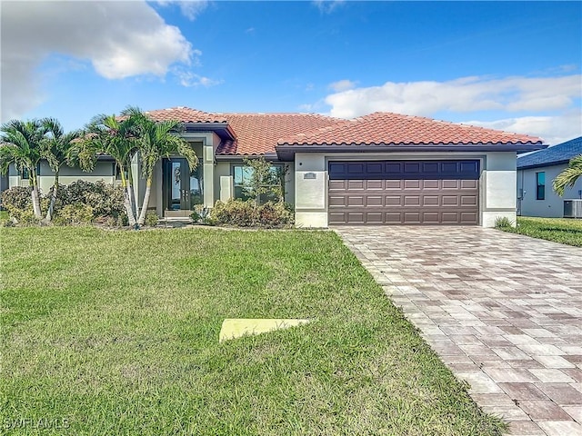 646 NE 5th Place, Cape Coral, FL 33909 - mediterranean / spanish home featuring stucco siding, decorative driveway, a front yard, and a tile roof