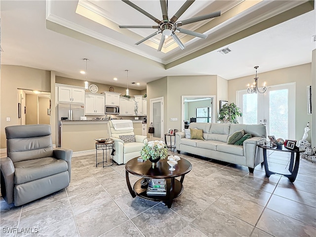 living room featuring ceiling fan with notable chandelier, a raised ceiling, and ornamental molding