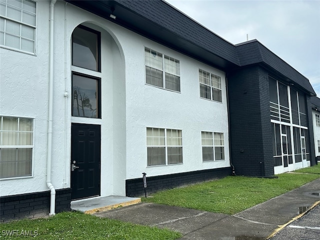 view of side of property with a lawn