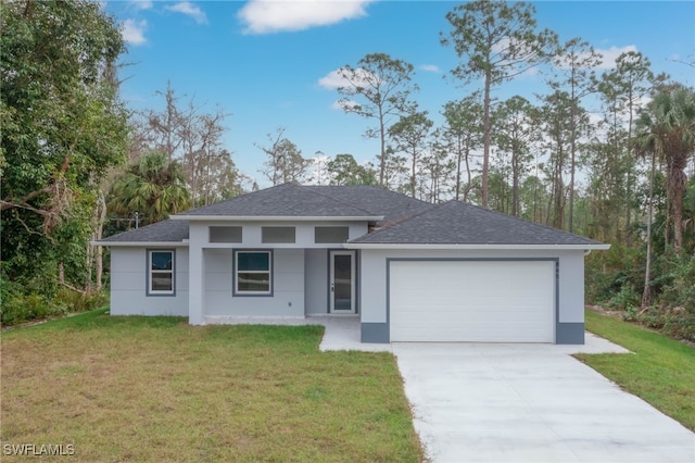 prairie-style house with a garage, concrete driveway, a front yard, and stucco siding