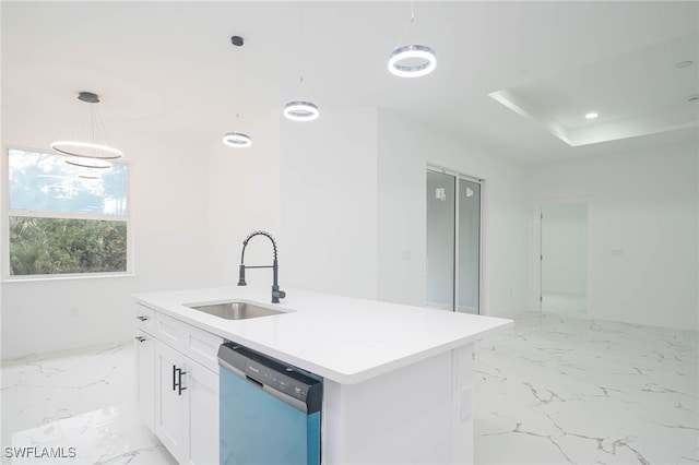 kitchen with a center island with sink, sink, hanging light fixtures, stainless steel dishwasher, and white cabinetry