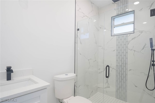 bathroom with toilet, vanity, and a marble finish shower