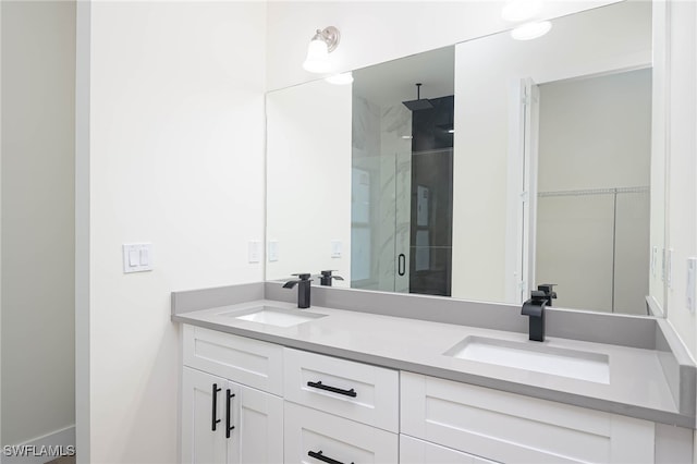 full bathroom with double vanity, a stall shower, a sink, and a walk in closet