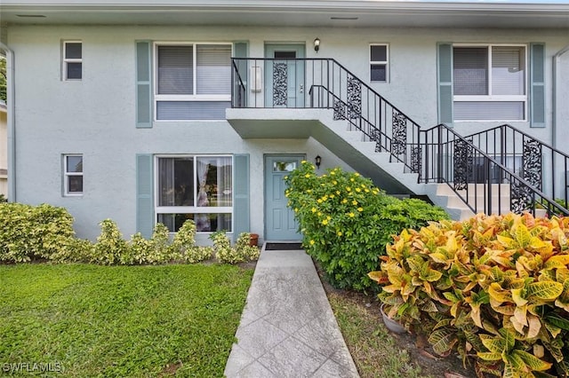 197 Harrison Rd Unit 7-3, Naples, FL 34112 - entrance to property with stucco siding and a lawn