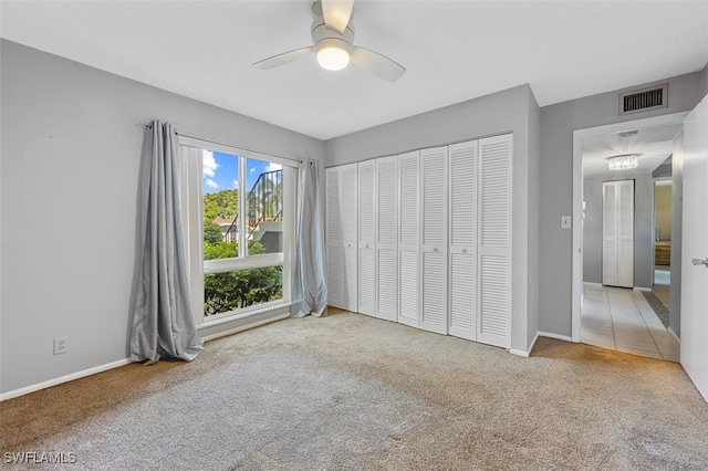 197 Harrison Rd Unit 7-3, Naples, FL 34112 - unfurnished bedroom with carpet, baseboards, a ceiling fan, and a closet