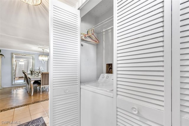 197 Harrison Rd Unit 7-3, Naples, FL 34112 - clothes washing area featuring washer / dryer, light tile patterned flooring, and a chandelier