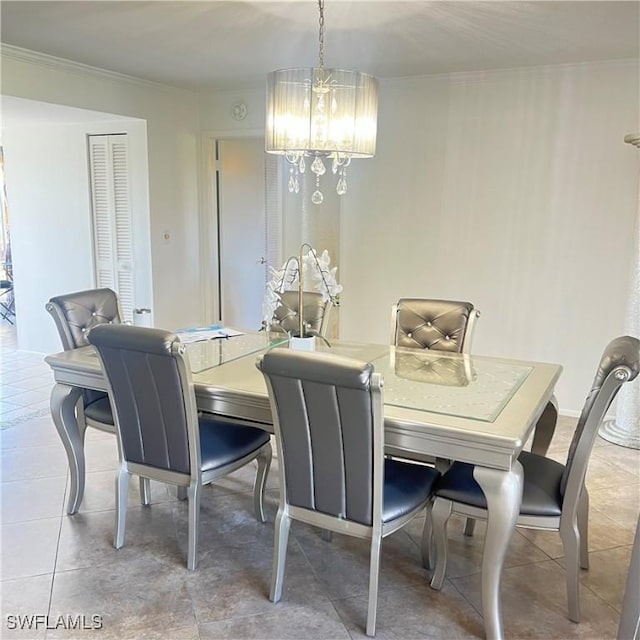 tiled dining area with a chandelier and ornamental molding