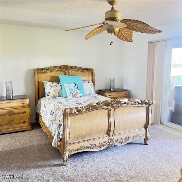 bedroom with ceiling fan, carpet, and a textured ceiling