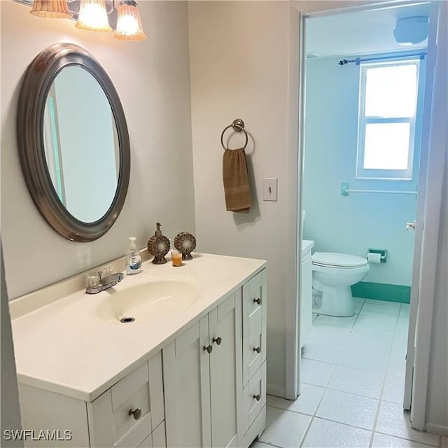 bathroom with tile patterned flooring, vanity, and toilet