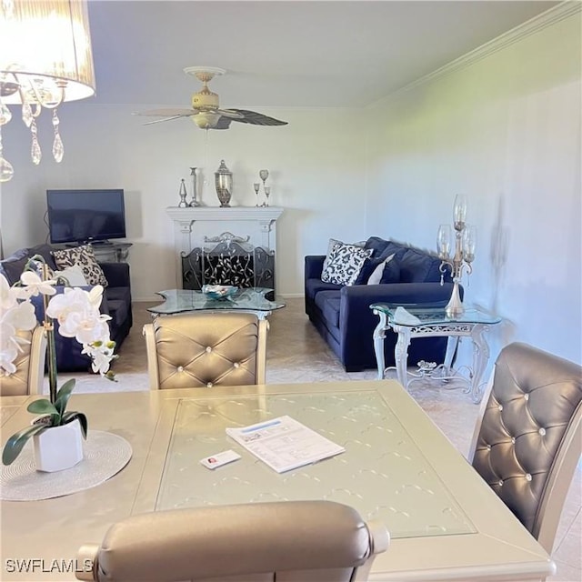 dining area with ceiling fan and ornamental molding