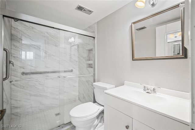 bathroom with walk in shower, vanity, and toilet