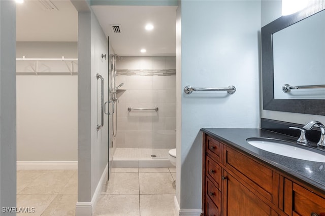 bathroom with visible vents, baseboards, tile patterned floors, vanity, and a shower stall