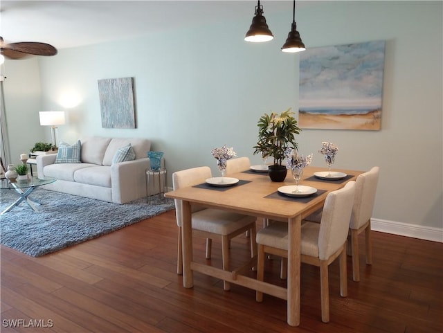 dining area featuring dark wood-style floors, ceiling fan, and baseboards