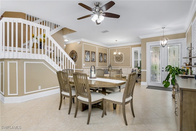 dining room with ceiling fan with notable chandelier, ornamental molding, and light tile patterned floors