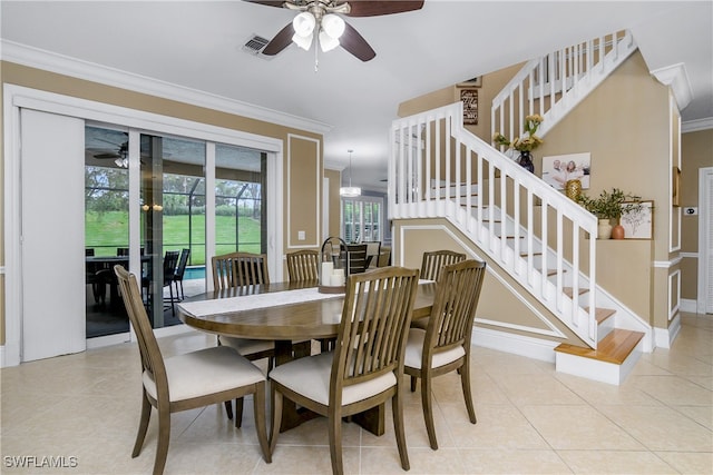 dining space featuring ceiling fan, crown molding, and light tile patterned floors