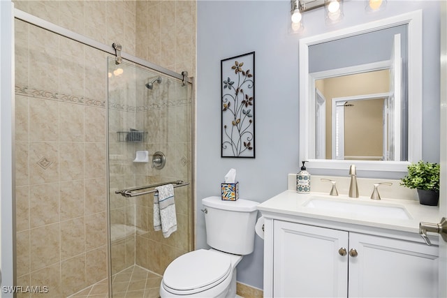 bathroom with walk in shower, vanity, and toilet