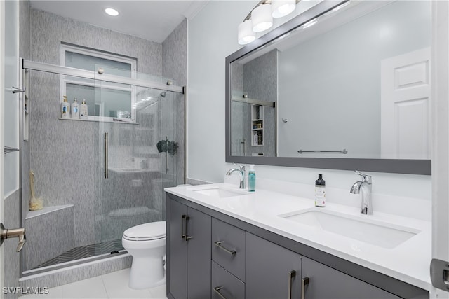 bathroom with tile patterned floors, vanity, walk in shower, and toilet