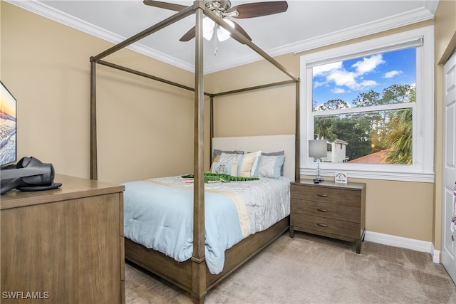 carpeted bedroom with ceiling fan and crown molding