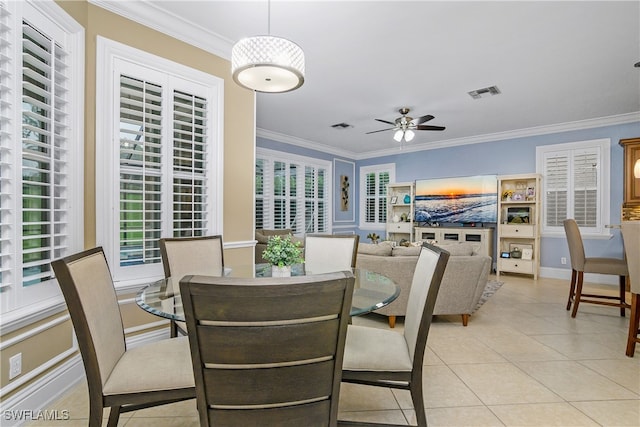 dining room featuring crown molding, light tile patterned floors, and ceiling fan